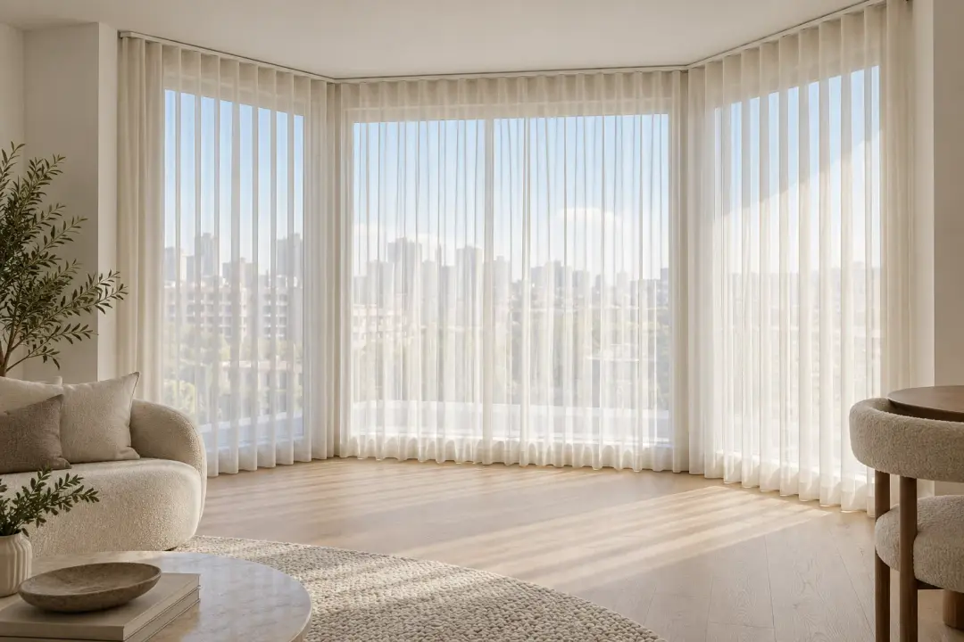 S-fold sheer curtains following an angled bay window in a Sydney apartment