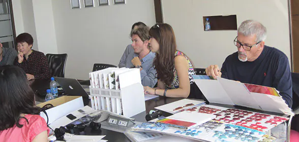 People reviewing colour and textile samples at a worktable