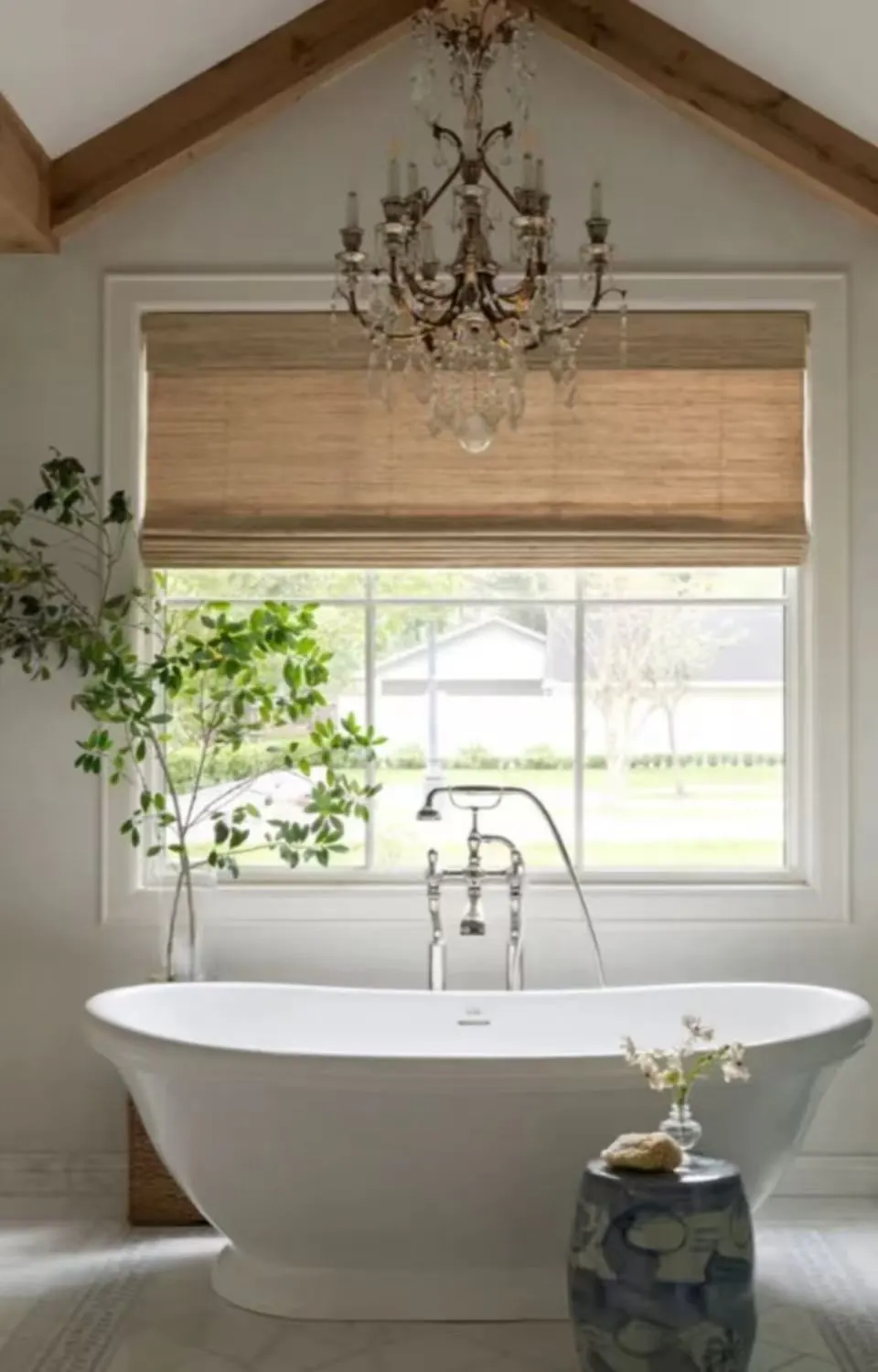 Natural woven Roman blind in an arched bathroom window