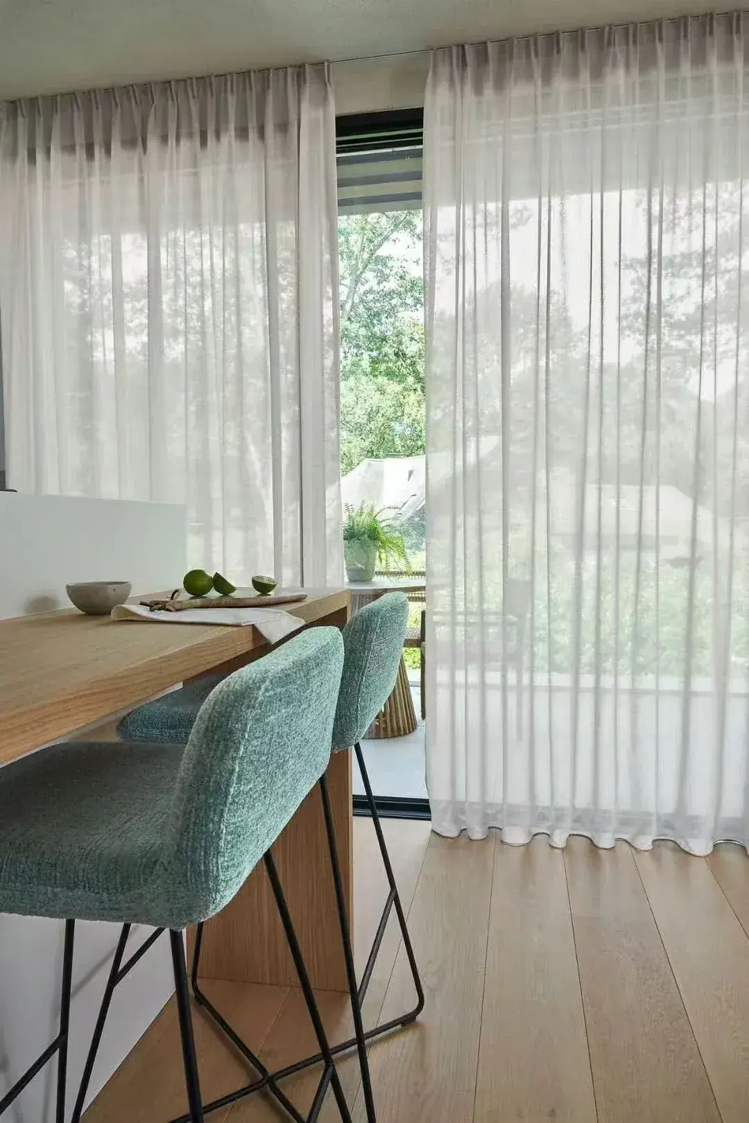 Sheer curtain with disciplined folds at a glazed doorway